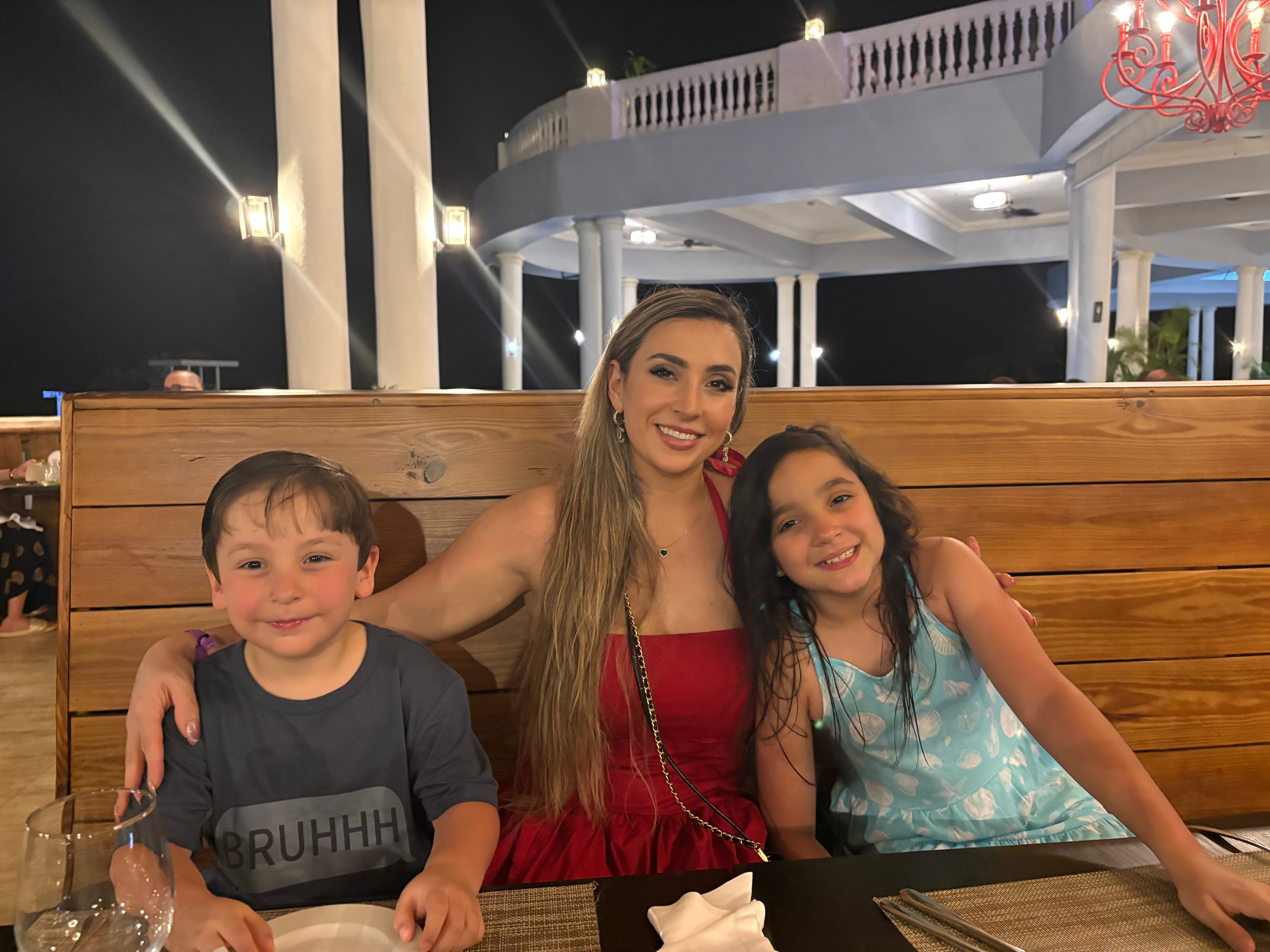 Laura, Drobe founder, with her two children at a restaurant in the evening